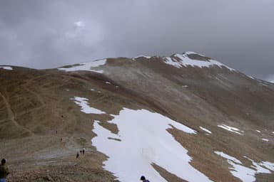 Mount Sherman from the saddle with Mount Sheridan on a snowy day