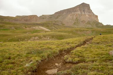 View of Uncompahgre Peak's tall Northern cliffs seen from the Nellie Creek Trail